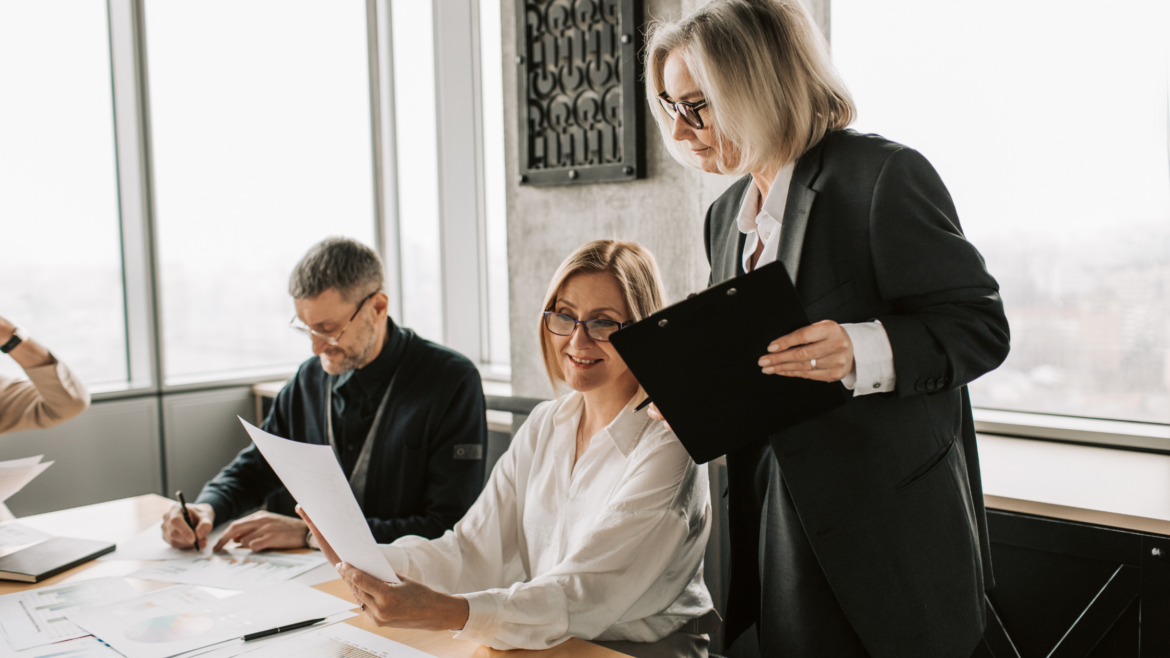 Employees having a meeting at the office during a time study for employees